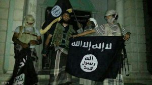 A picture taken with a mobile phone early on May 24, 2014 shows Al-Qaeda militants posing with Al-Qaeda flags in front of a museum in Seiyun, second Yemeni city of Hadramawt province, after launching a massive pre-dawn assault that killed at least 15 soldiers and police. The assault in Hadramawt, a jihadist stronghold that has seen large-scale attacks on the army in the past, came as troops pressed a month-old ground offensive against Al-Qaeda in Abyan and Shabwa provinces to the west. AFP PHOTO / STR (Photo credit should read -/AFP/Getty Images)